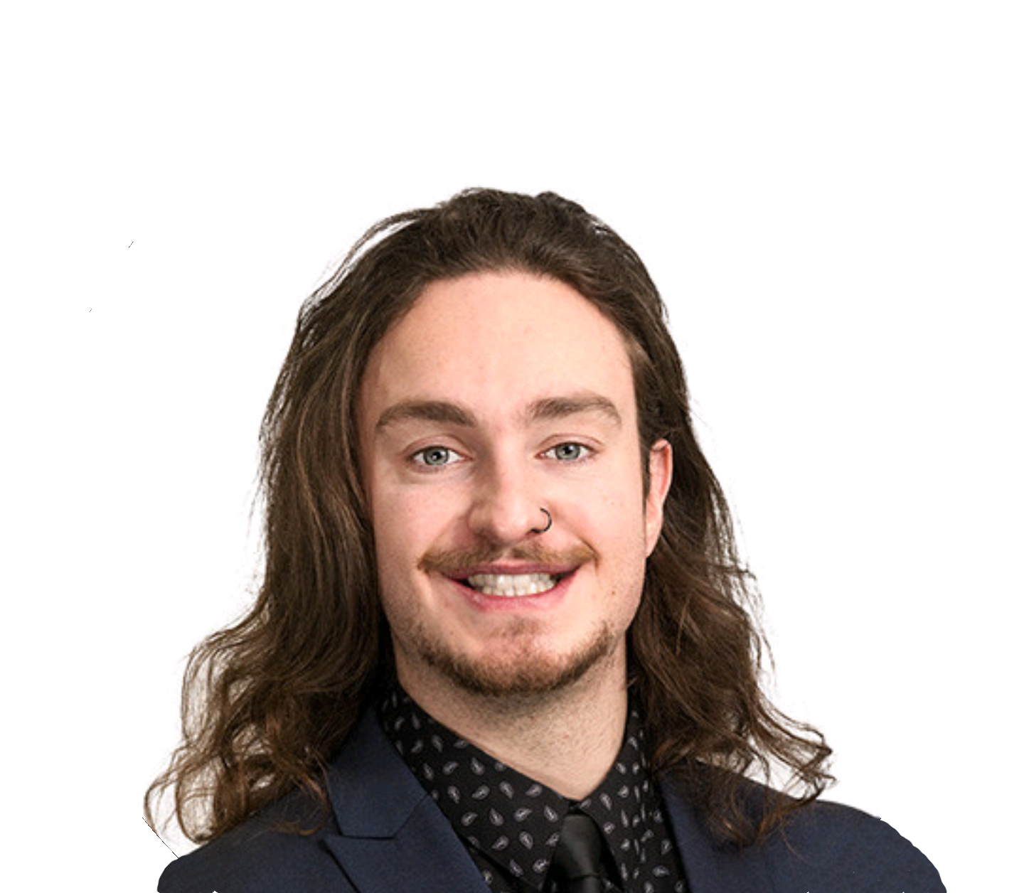 A man smiling. He has long hair