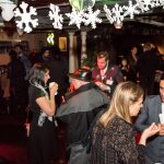 A Christmas event, lots of people talking.