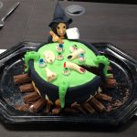 A witch and a cauldron themed halloween cake