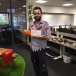 1 man holding what looks like pumpkins and a note