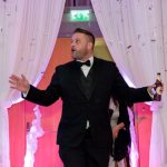 A man with a beer in hand looking very surprised