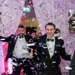 people walking through confetti