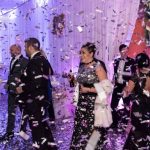 group of people at party. confetti in the air