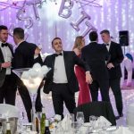 Group of people at an awards/event show throwing snowballs