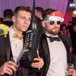 2 men one has a very large phone